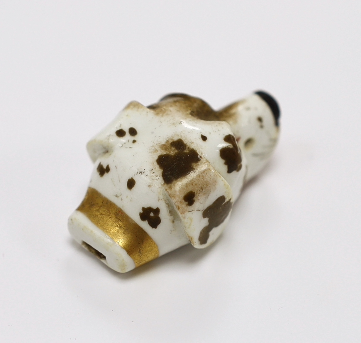 An early 19th century Staffordshire porcelain dog’s head whistle, 4.5cm